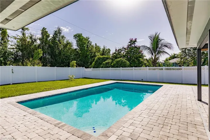 View of pool with a patio area and a fenced backyard