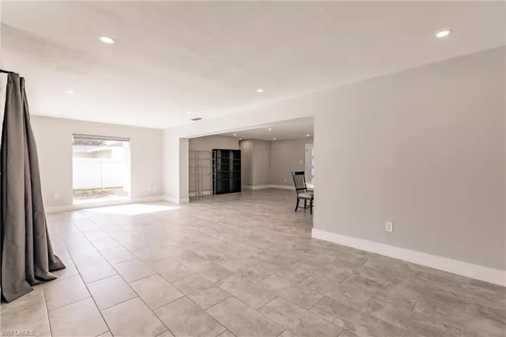 Unfurnished living room with recessed lighting and light tile patterned floors