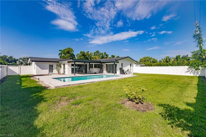 Rear view of property with a fenced backyard, a patio, and stucco siding