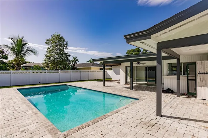 View of pool with a patio and a fenced backyard