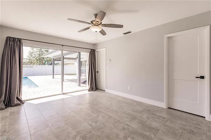 Unfurnished room with baseboards and ceiling fan