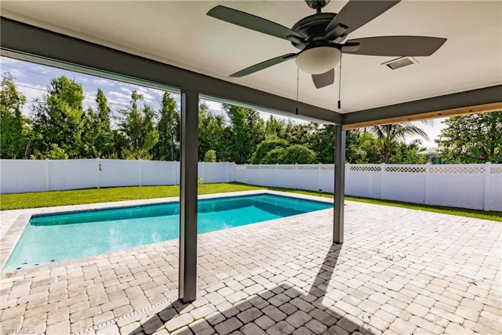 View of swimming pool featuring a fenced backyard and a patio area