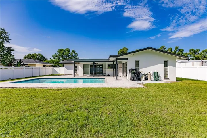 Back of property featuring a fenced backyard, a patio, stucco siding, and a ceiling fan