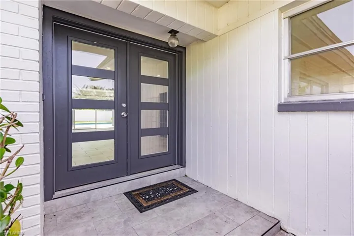 Property entrance featuring french doors
