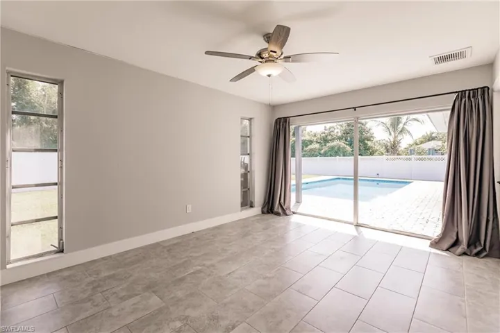 Empty room featuring plenty of natural light and ceiling fan