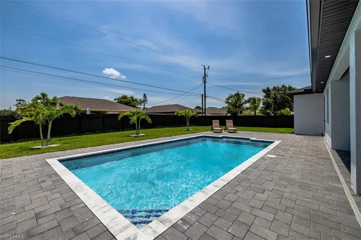 View of swimming pool with a lawn and a patio area