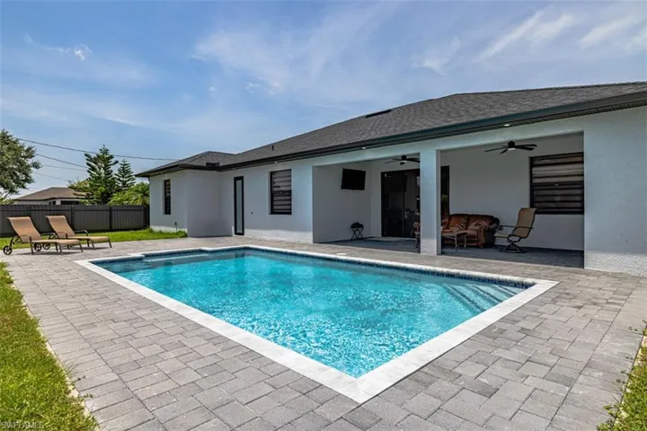 View of pool featuring a patio and ceiling fan