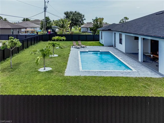 View of pool featuring a patio and a yard