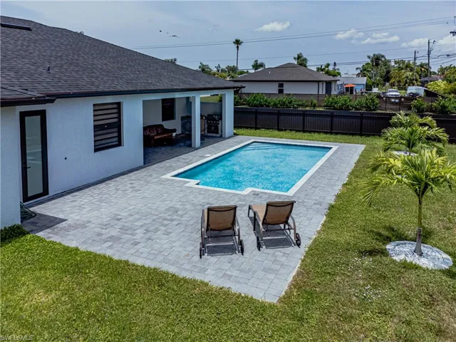 View of swimming pool with a yard and a patio area
