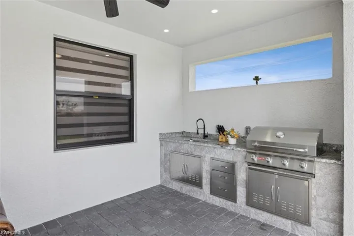 View of patio featuring exterior kitchen, sink, and area for grilling