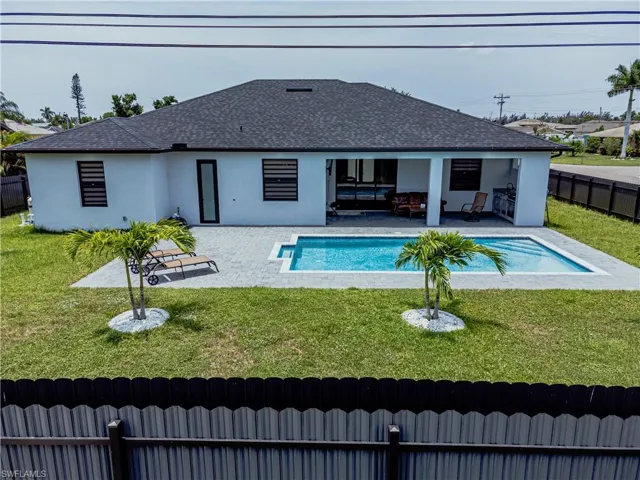 View of swimming pool featuring a patio and a lawn