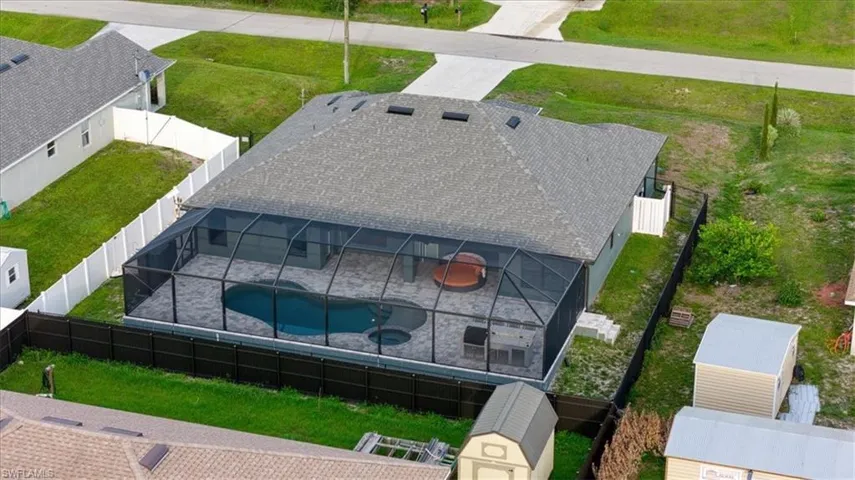 Single-story residence featuring a screened-in swimming pool and spa