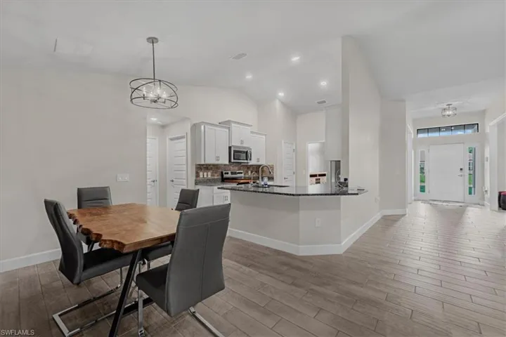 Open concept living area featuring wood-finish tile flooring and a neutral color palette