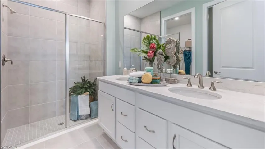 Dual vanity with undermount sinks, stone countertop, and brushed nickel fixtures