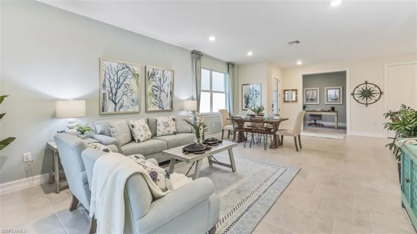 Open-concept living area with large format tile flooring, recessed lighting, and a dedicated dining space