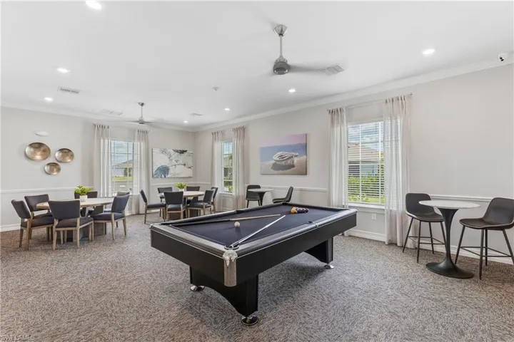 Spacious common area featuring a billiards table, recessed lighting, ceiling fans, multiple seating arrangements, and window blinds
