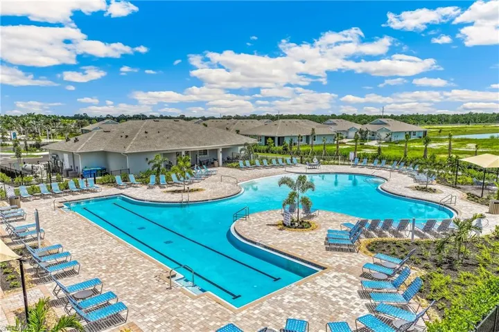 Expansive aquatic center featuring a lap pool, freeform pool, and surrounding lounge areas