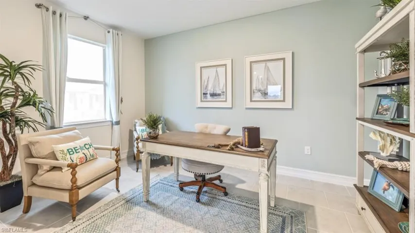 Window with curtain rod and drapes, light-toned wall paint, built-in shelving unit, and hard surface flooring