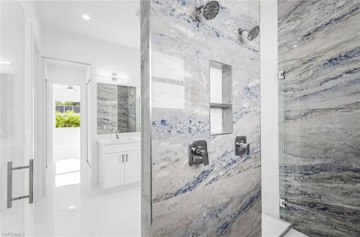 Bathroom with a shower with shower door and vanity
