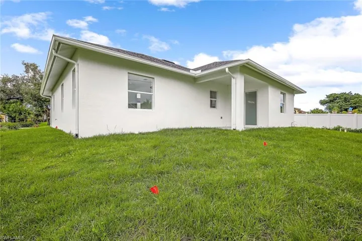 Back of property featuring a yard