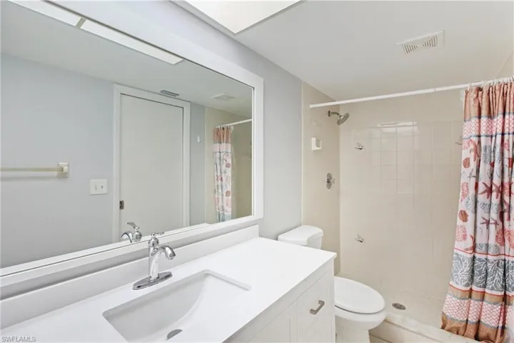 Bathroom with vanity and a shower stall