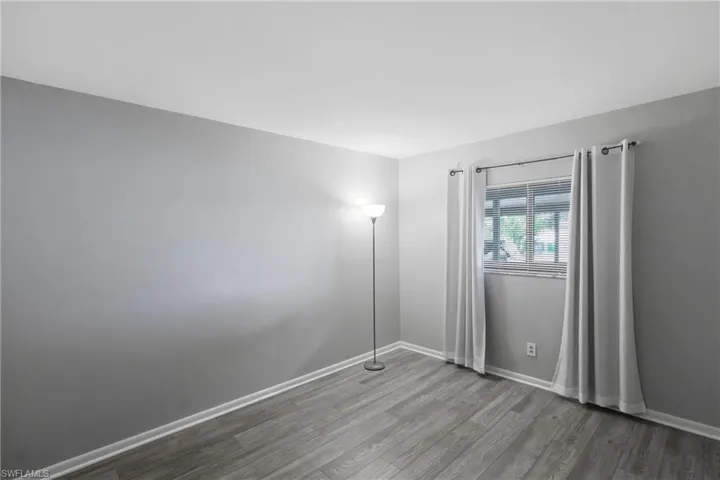 Spare room with light wood-style floors and baseboards