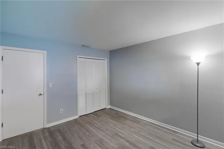 Unfurnished bedroom featuring wood finished floors and a closet