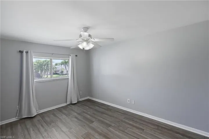 Unfurnished room featuring wood finished floors and a ceiling fan