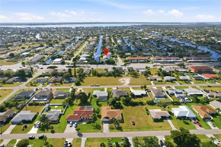 Aerial view of property's location with nearby suburban area and a nearby body of water