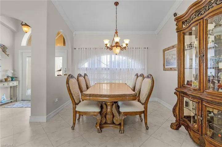 Dining room with a chandelier and crown molding