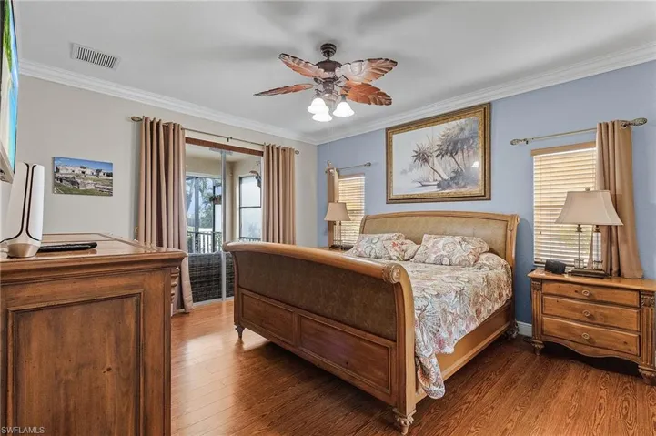 Bedroom with access to exterior, ceiling fan, dark hardwood / wood-style flooring, and ornamental molding
