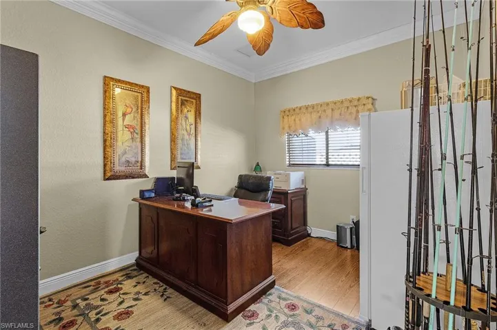 Office featuring ceiling fan, light hardwood / wood-style flooring, and ornamental molding