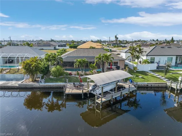 Dock area featuring a water view and a lawn