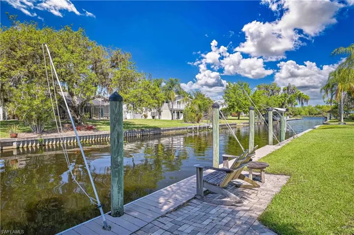 The property features a private waterfront dock with a paved seating area