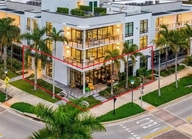 Modern multi-story building featuring white exterior finishes and extensive glass panels