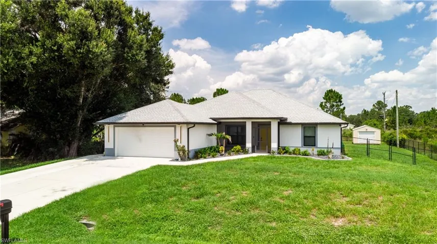 Contemporary single-story residence with a light gray shingle roof and white stucco exterior