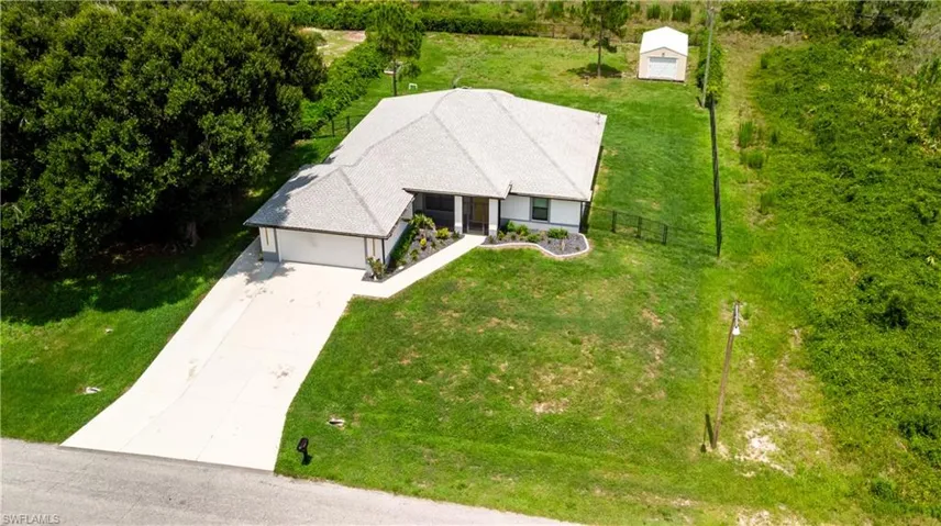 Ranch-style residence featuring a prominent front-facing garage and a concrete driveway