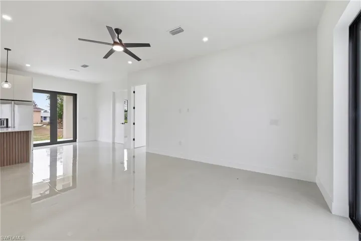 Unfurnished living room with concrete flooring, recessed lighting, and ceiling fan