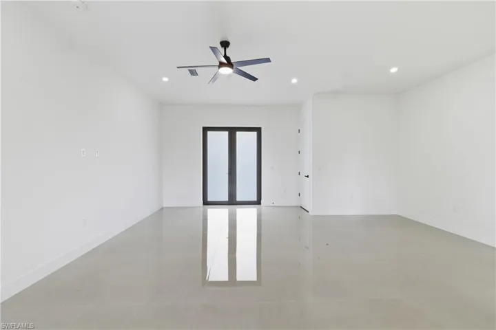 Empty room with ceiling fan, recessed lighting, and concrete floors