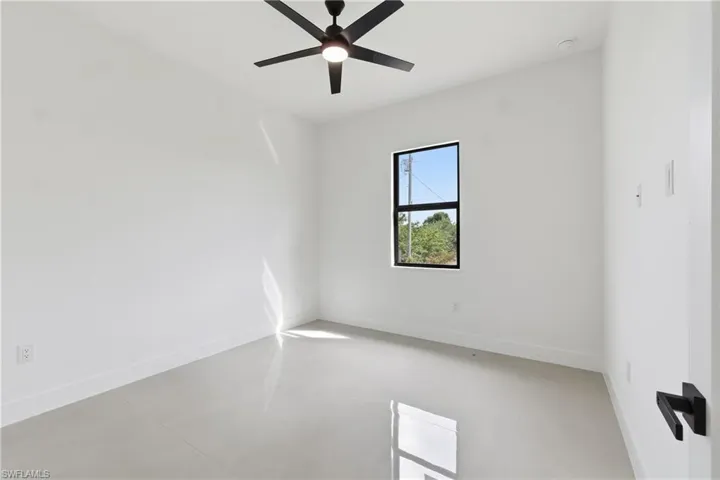 Empty room with a ceiling fan and concrete floors