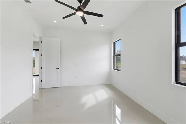 Unfurnished room with ceiling fan, finished concrete floors, and recessed lighting