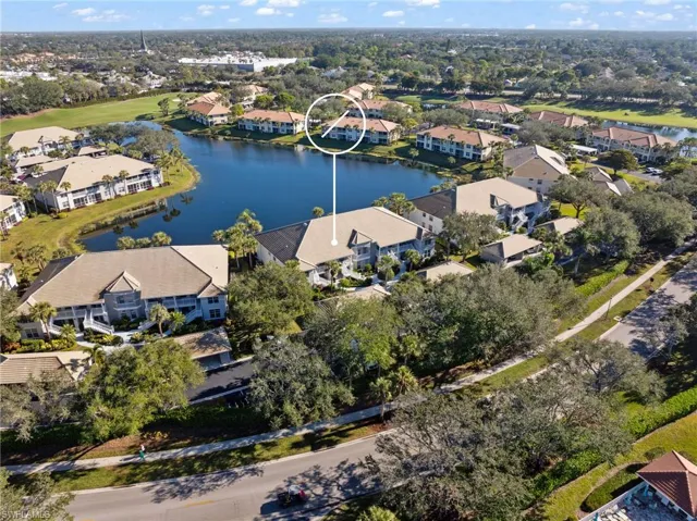 Birds eye view of property with a water view