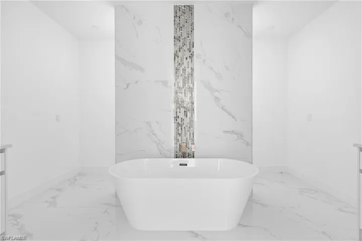 Full bath featuring vanity and a soaking tub