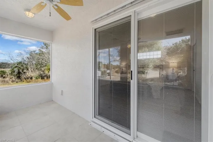Screened lanai slider entrance to private guest bedroom