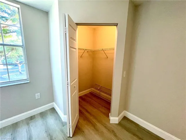 This inviting primary bedroom features ample space, enhanced by a generously sized walk-in closet, providing excellent storage and organization.