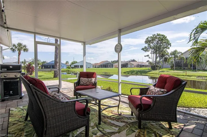 Sunroom with a water view and a residential view