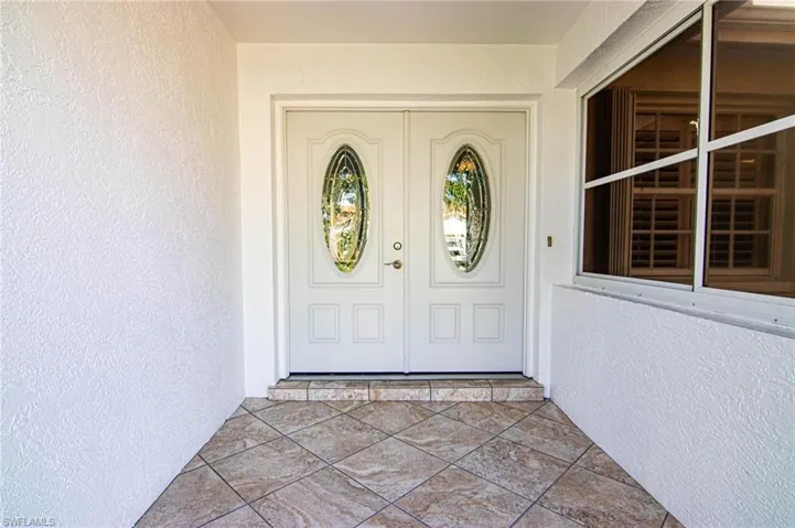 Entrance to property with stucco siding