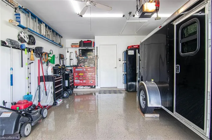 Garage featuring ceiling fan and a garage door opener
