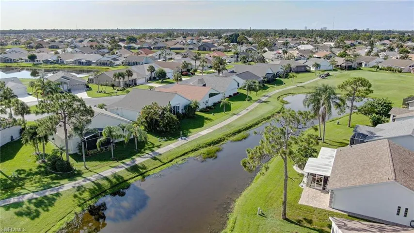 Aerial view of residential area featuring a nearby body of water