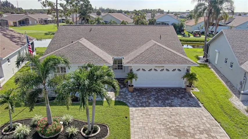 Aerial perspective of suburban area featuring a large body of water